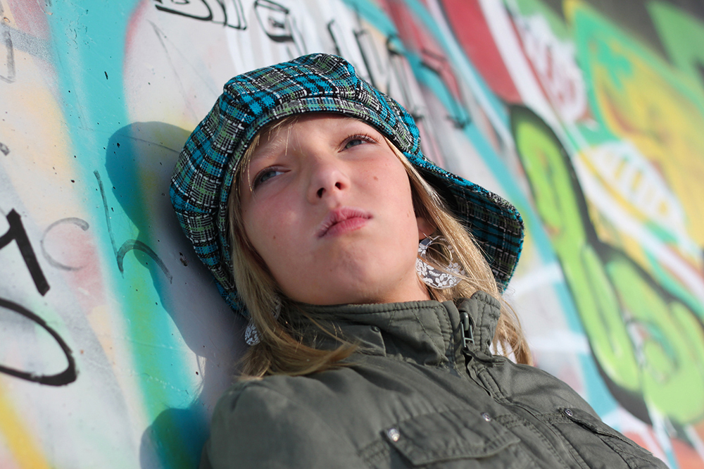 Teenager vor einer Graffitiwand